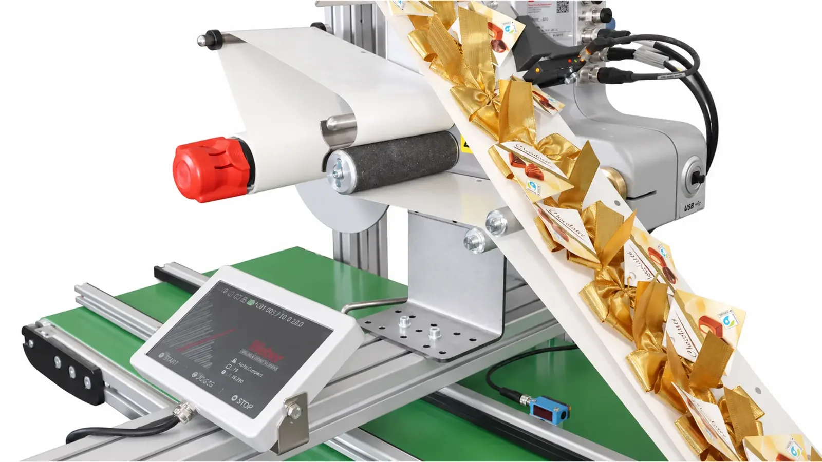 Touch-Bedienpanel und Dispenser mit goldenen Schleifen am Förderband